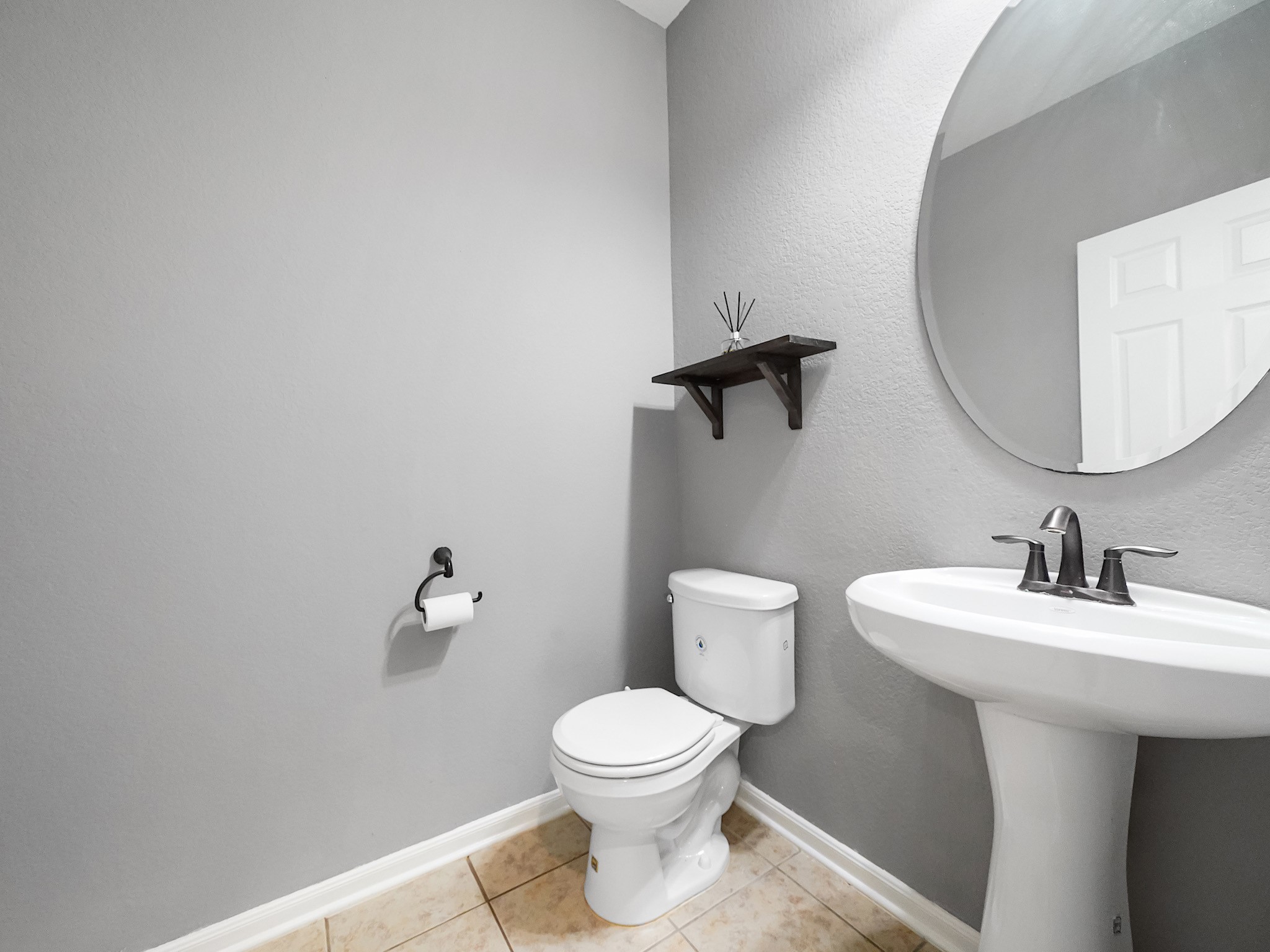 24131 Adobe Ridge Lane Katy, TX 77493 - Photo 17 of 37 a bathroom with a toilet a sink and mirror