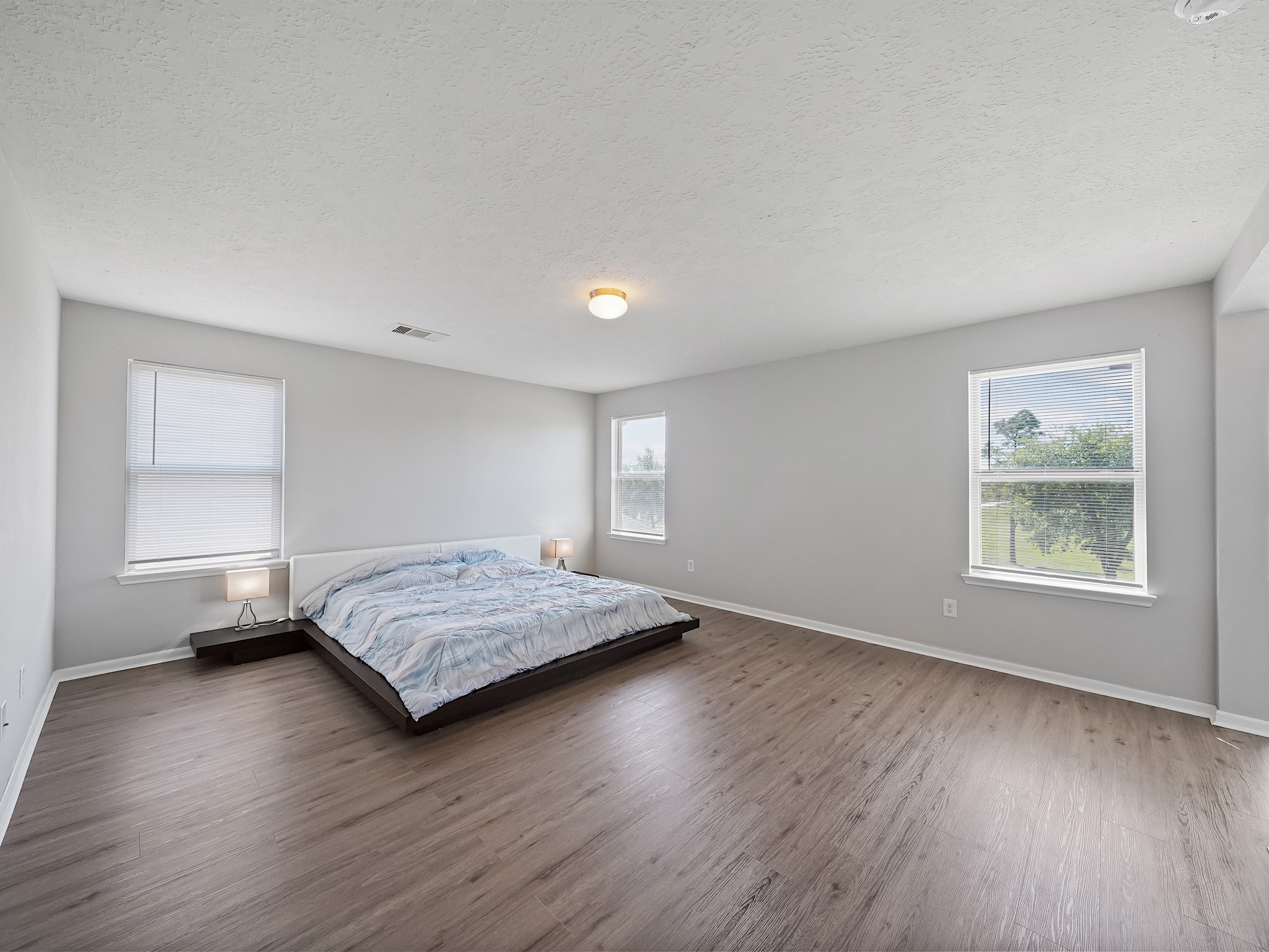 24131 Adobe Ridge Lane Katy, TX 77493 - Photo 19 of 37 a bedroom with a bed and wooden floor