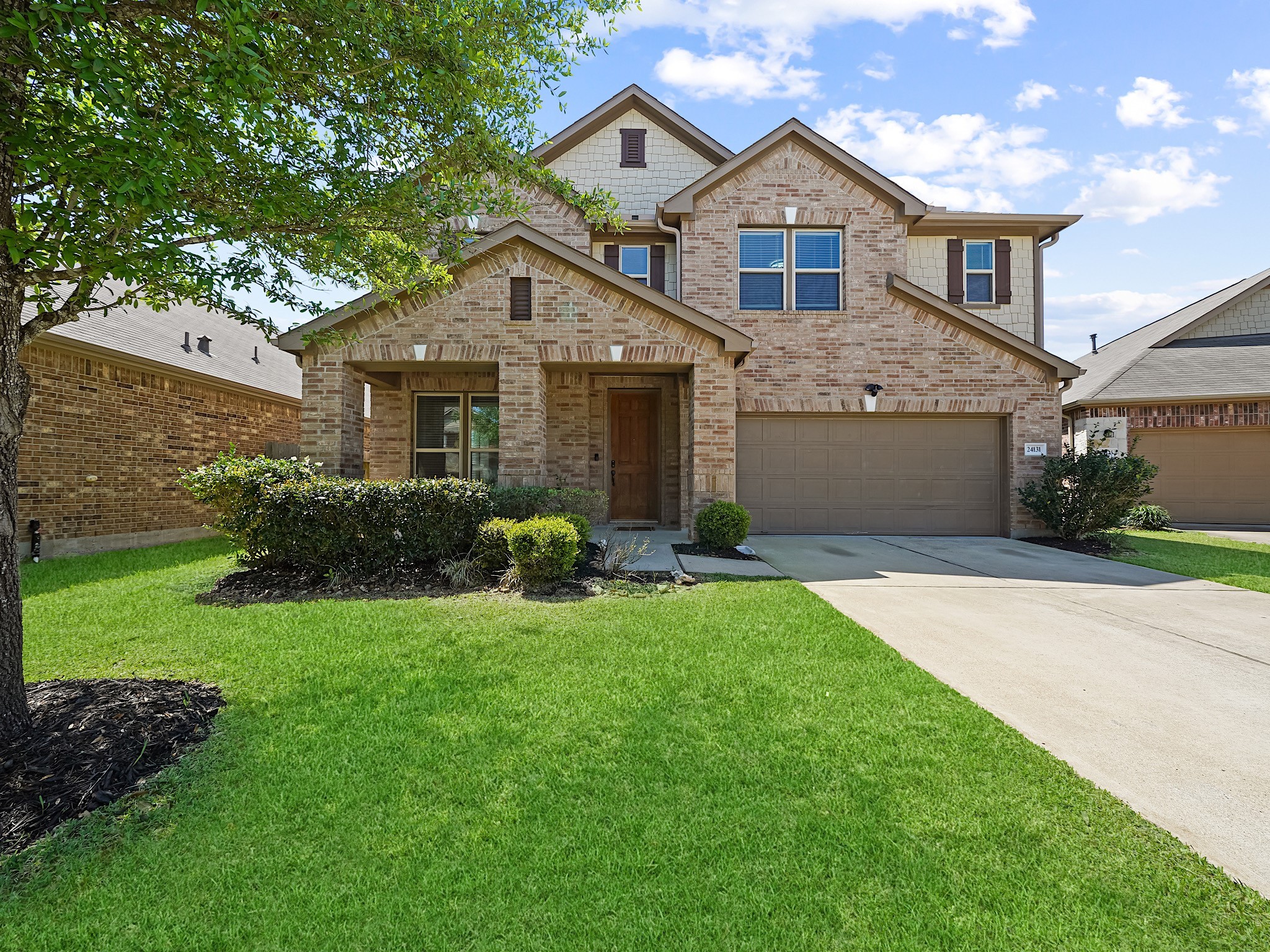 24131 Adobe Ridge Lane Katy, TX 77493 - Photo 2 of 37 a front view of a house with a yard and garage