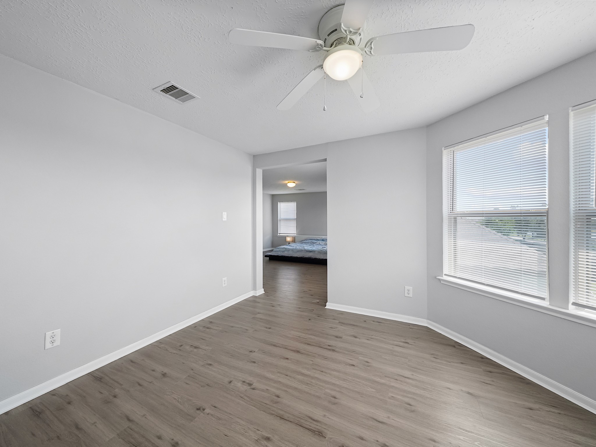 24131 Adobe Ridge Lane Katy, TX 77493 - Photo 23 of 37 an empty room with wooden floor and windows