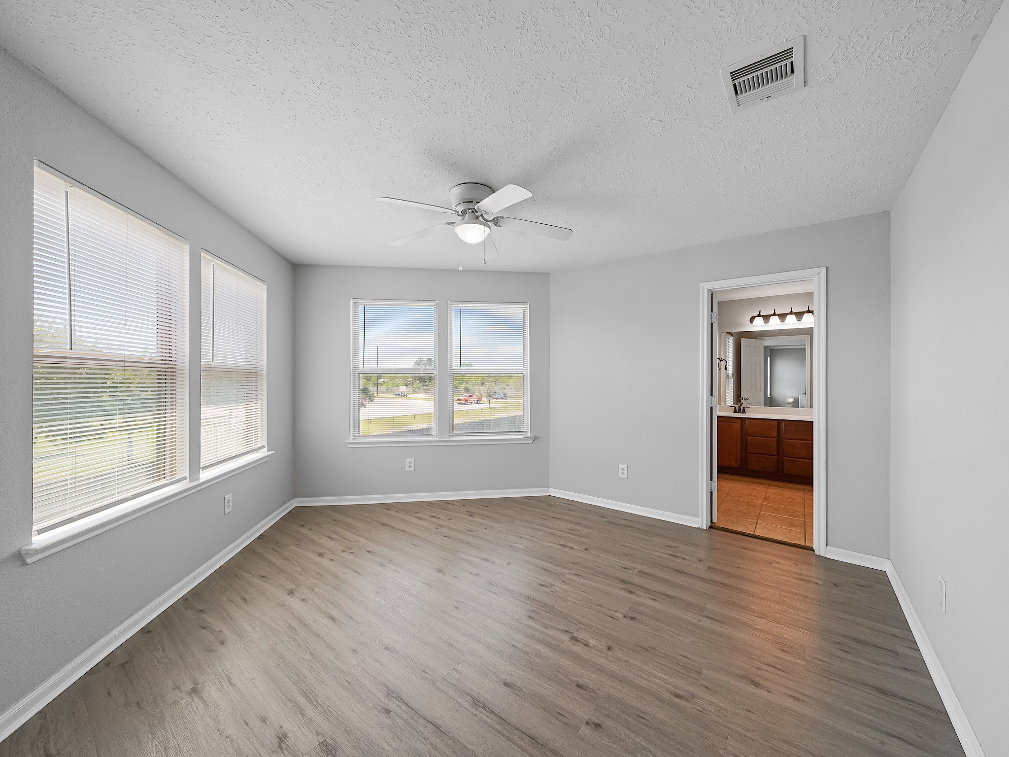 24131 Adobe Ridge Lane Katy, TX 77493 - Photo 24 of 37 a view of an empty room with a window and wooden floor