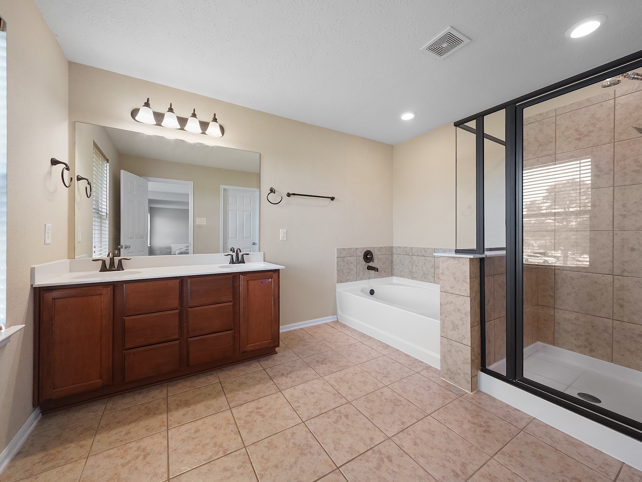 24131 Adobe Ridge Lane Katy, TX 77493 - Photo 26 of 37 a spacious bathroom with a tub sink and mirror