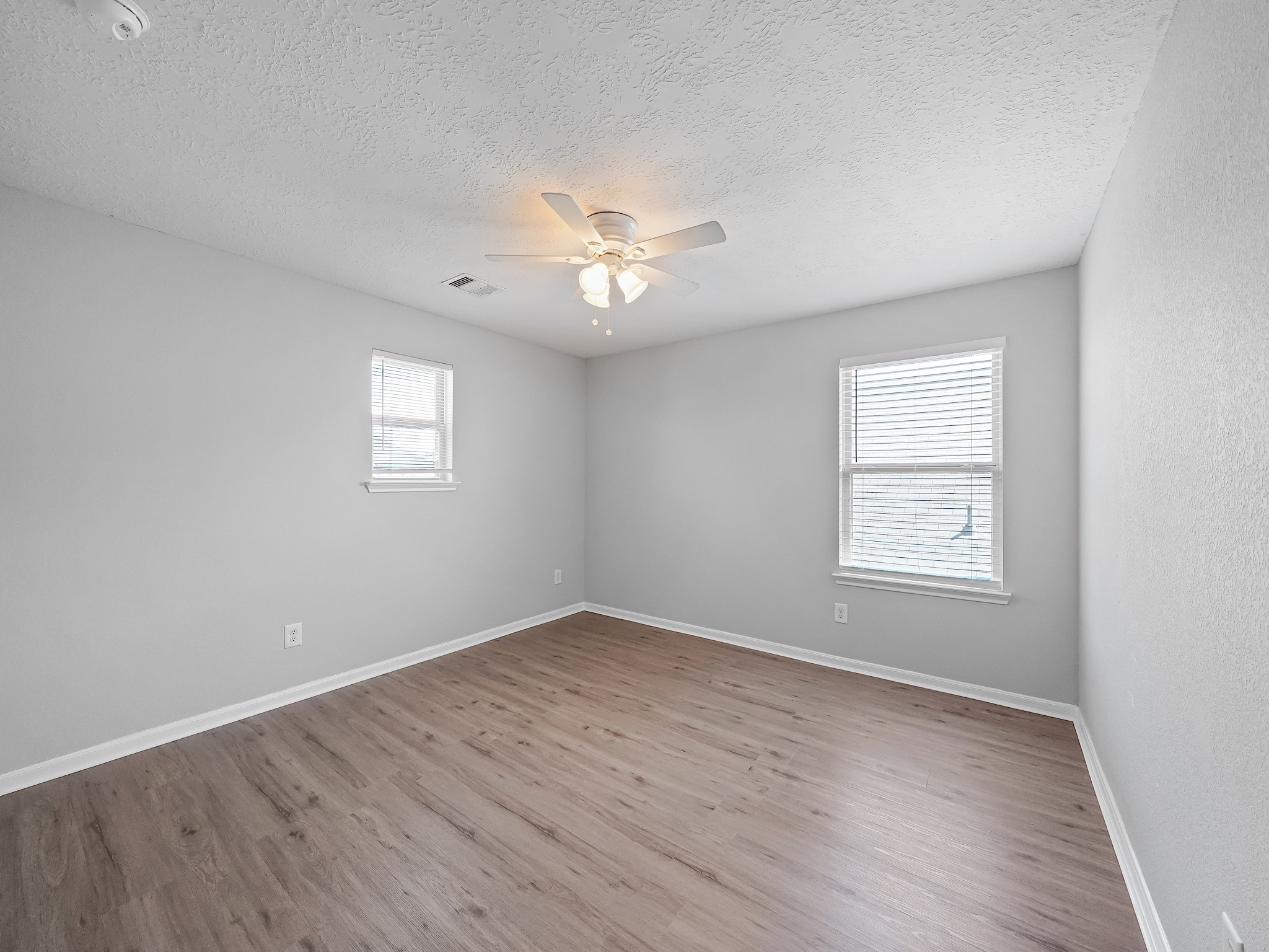 24131 Adobe Ridge Lane Katy, TX 77493 - Photo 29 of 37 an empty room with wooden floor and windows