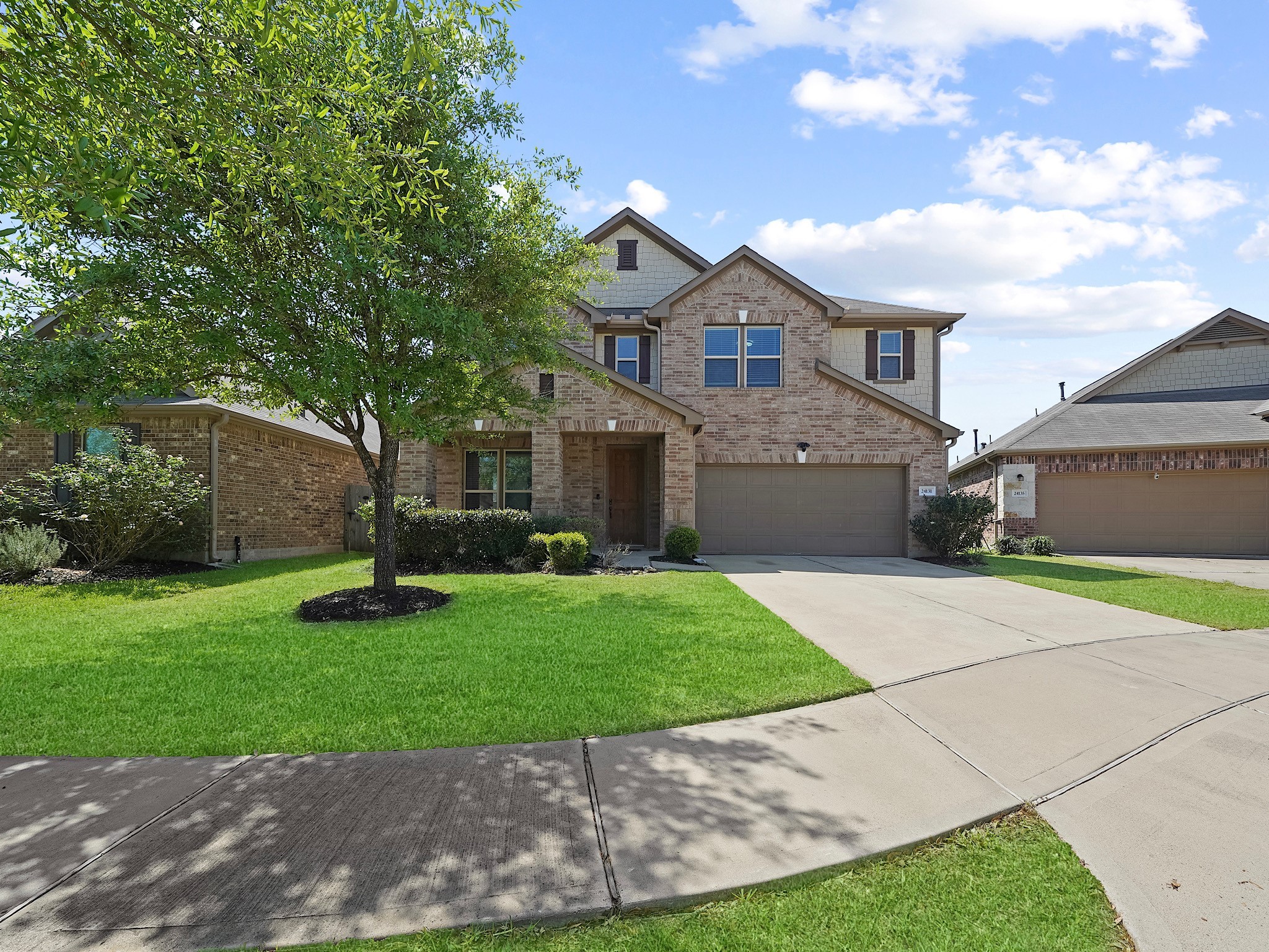 24131 Adobe Ridge Lane Katy, TX 77493 - Photo 3 of 37 a front view of a house with a yard and garage