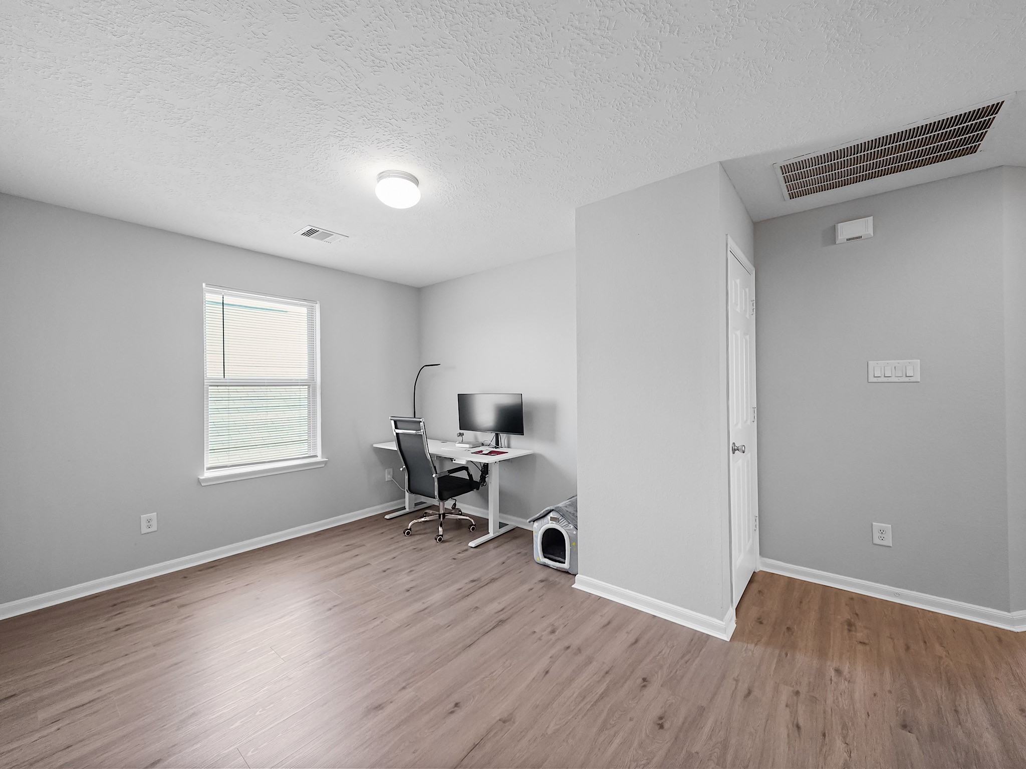 24131 Adobe Ridge Lane Katy, TX 77493 - Photo 32 of 37 a view of a workspace with wooden floor and a window