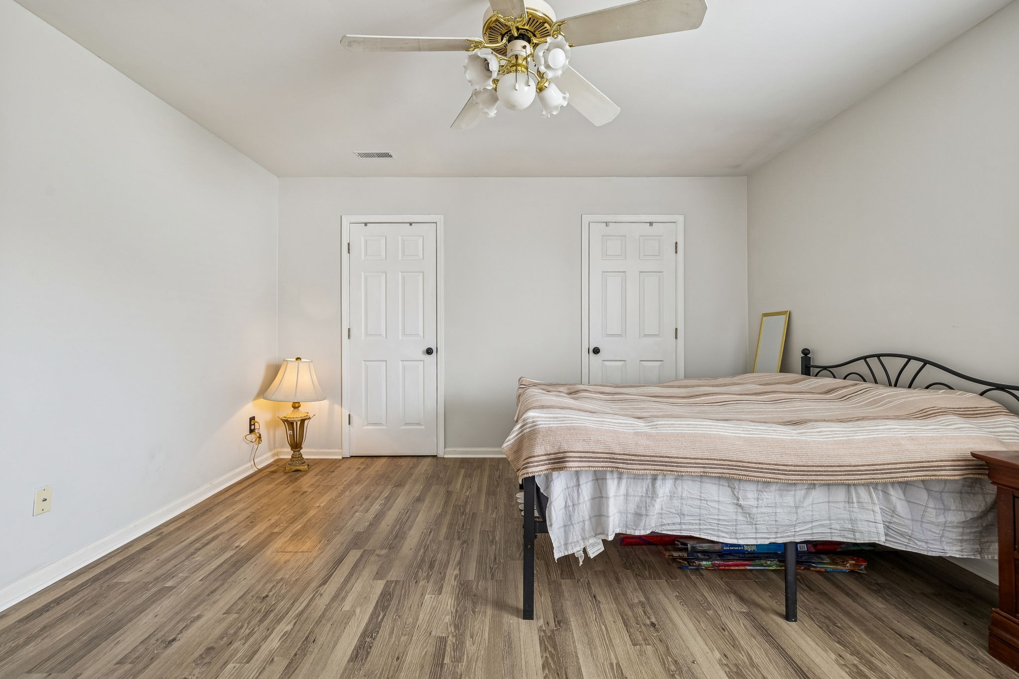 7701 Poplar Ridge Drive Nashville, TN 37221 - Photo 18 of 28 a bedroom with a bed and wooden floor