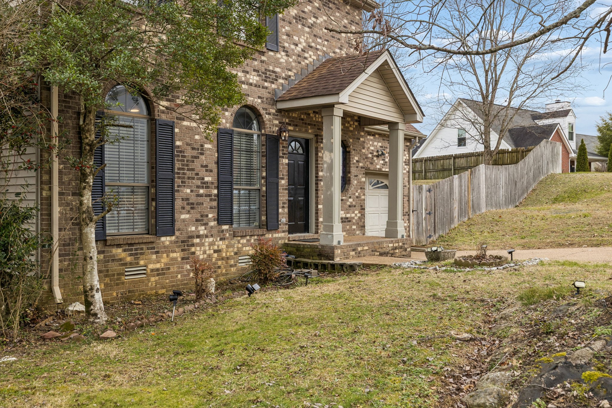 7701 Poplar Ridge Drive Nashville, TN 37221 - Photo 2 of 28 a front view of a house with garden