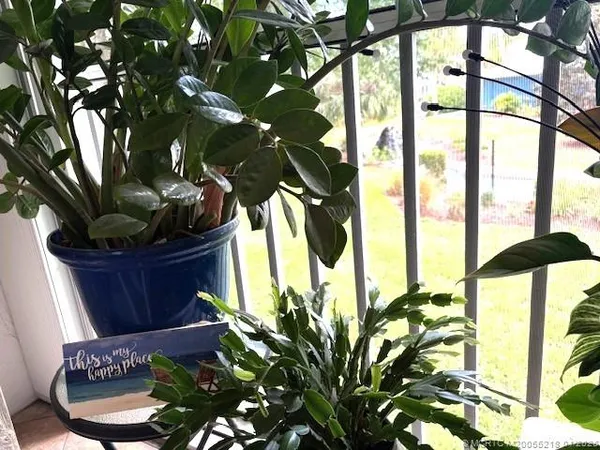 a view of a patio with table and chairs with wooden floor and fence