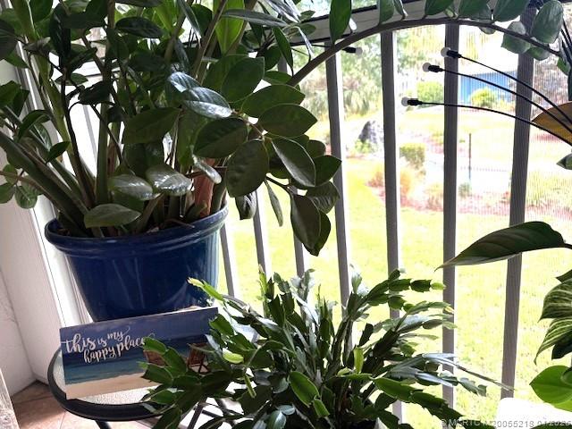1854 Southwest Palm City Road, Unit 203 Stuart, FL 34994 - Photo 19 of 38 a room with a large window and a potted plant