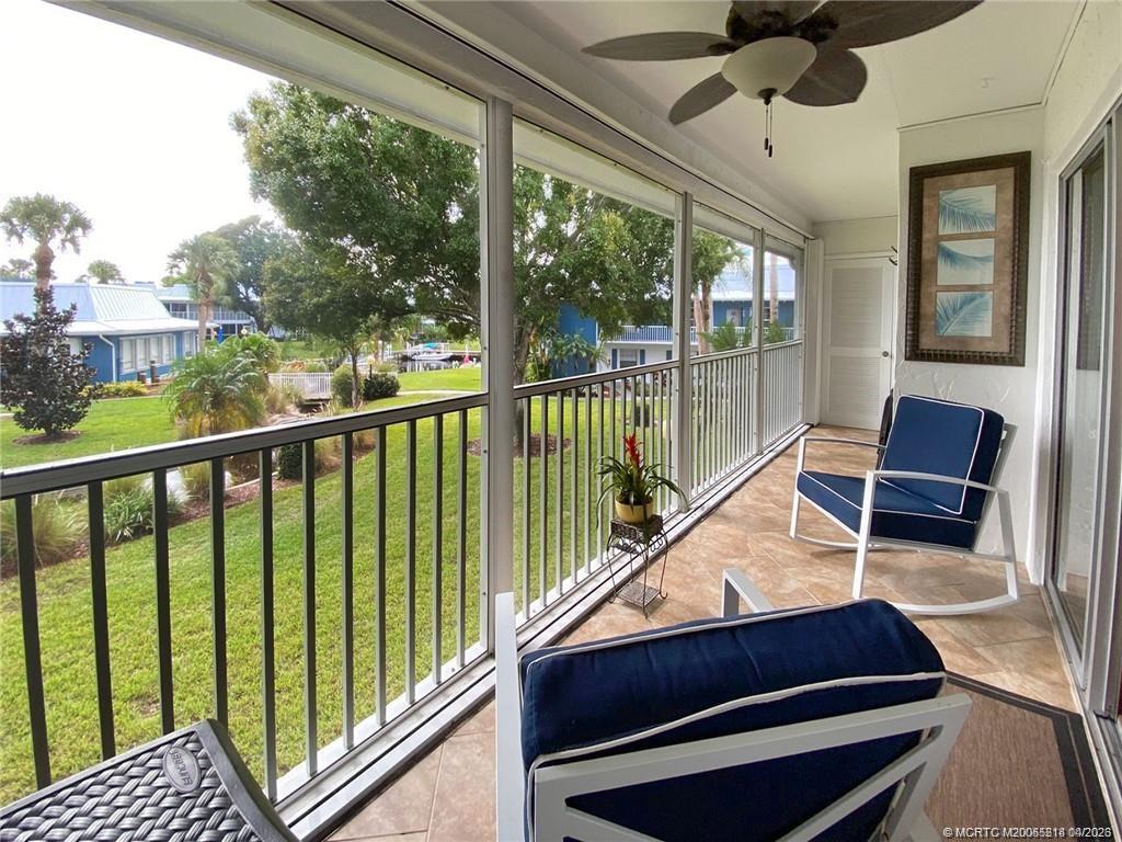 1854 Southwest Palm City Road, Unit 203 Stuart, FL 34994 - Photo 2 of 27 This oversized screened lanai truly feels like an outdoor living room—perfect for relaxing or entertaining while enjoying serene green space and water views with gentle Florida breezes.