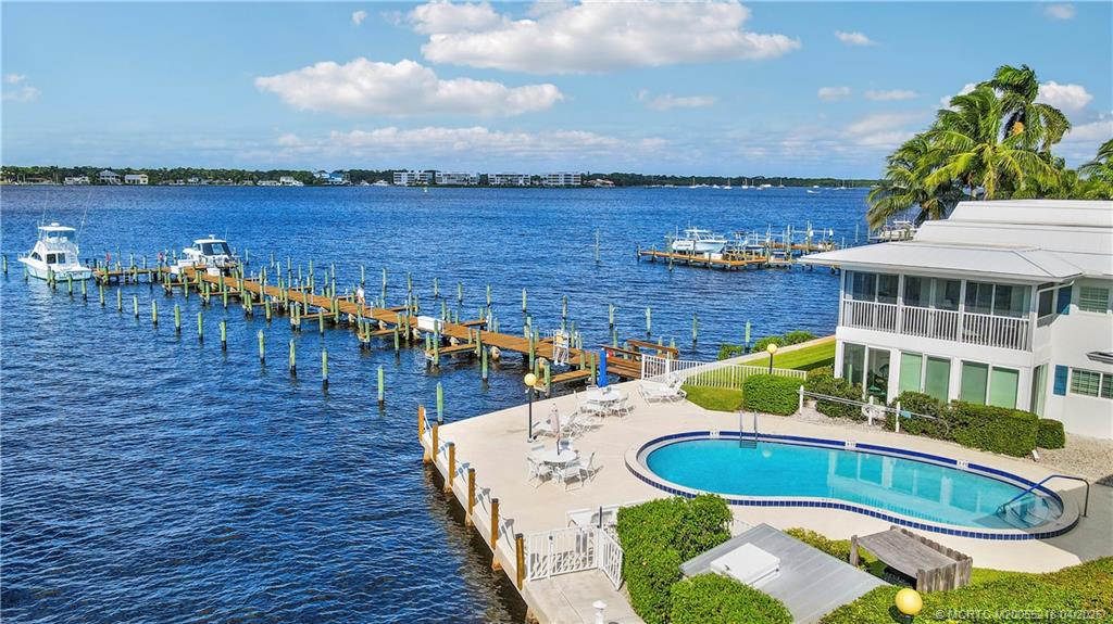 1854 Southwest Palm City Road, Unit 203 Stuart, FL 34994 - Photo 26 of 27 Enjoy true Florida living with three heated pools (this pool is the Riverfront pool, waterfront lounging areas, and boat docks just steps away—perfect for boating, relaxing, and soaking in the coastal lifestyle