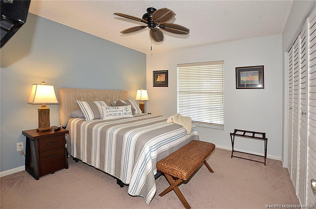 1854 Southwest Palm City Road, Unit 203 Stuart, FL 34994 - Photo 26 of 38 a bedroom with a bed and a chair