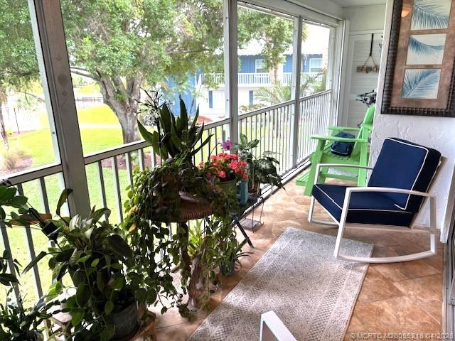 1854 Southwest Palm City Road, Unit 203 Stuart, FL 34994 - Photo 3 of 38 a view of a chairs and table in a patio