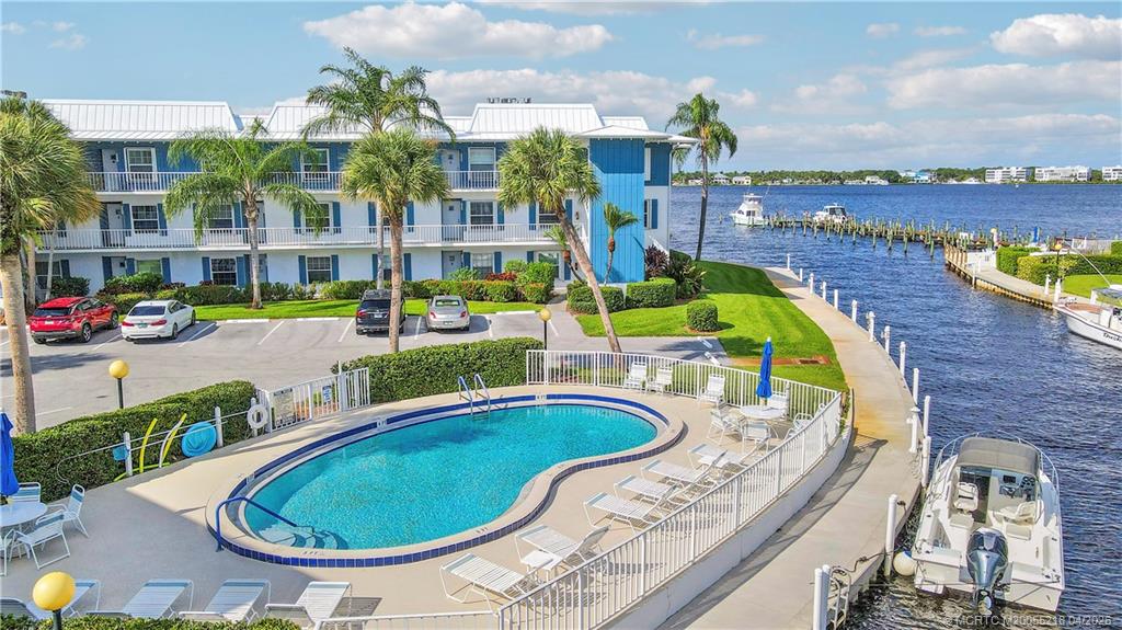 1854 Southwest Palm City Road, Unit 203 Stuart, FL 34994 - Photo 35 of 38 a swimming pool with outdoor seating and city view