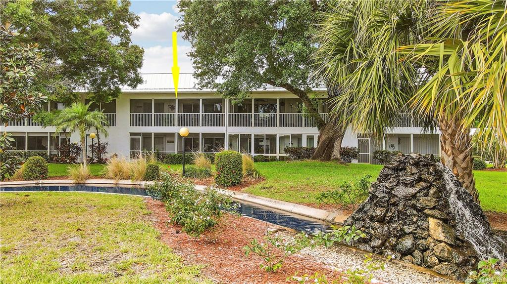 1854 Southwest Palm City Road, Unit 203 Stuart, FL 34994 - Photo 37 of 38 a front view of a house with a yard