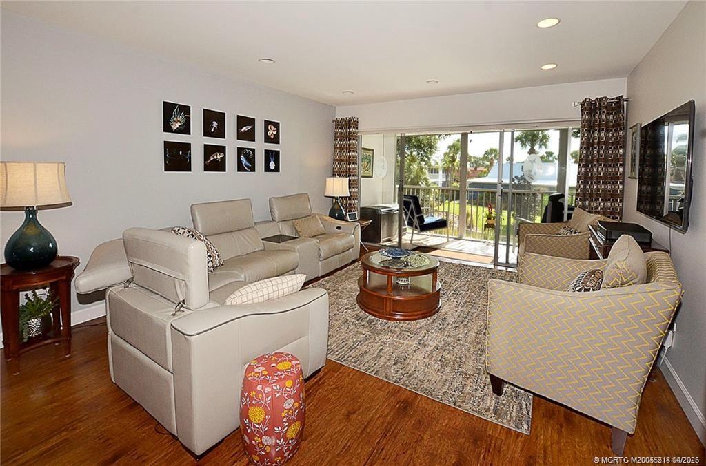 1854 Southwest Palm City Road, Unit 203 Stuart, FL 34994 - Photo 5 of 27 The bright, open living room offers plenty of space to relax or entertain, with sliding glass doors that seamlessly connect to the screened lanai and bring in beautiful natural light.