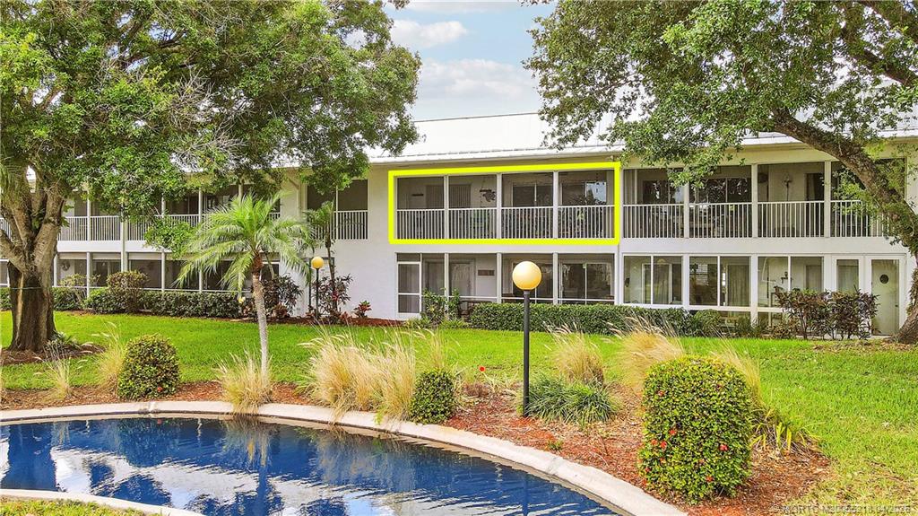 1854 Southwest Palm City Road, Unit 203 Stuart, FL 34994 - Photo 8 of 38 a view of a swimming pool with a garden and plants