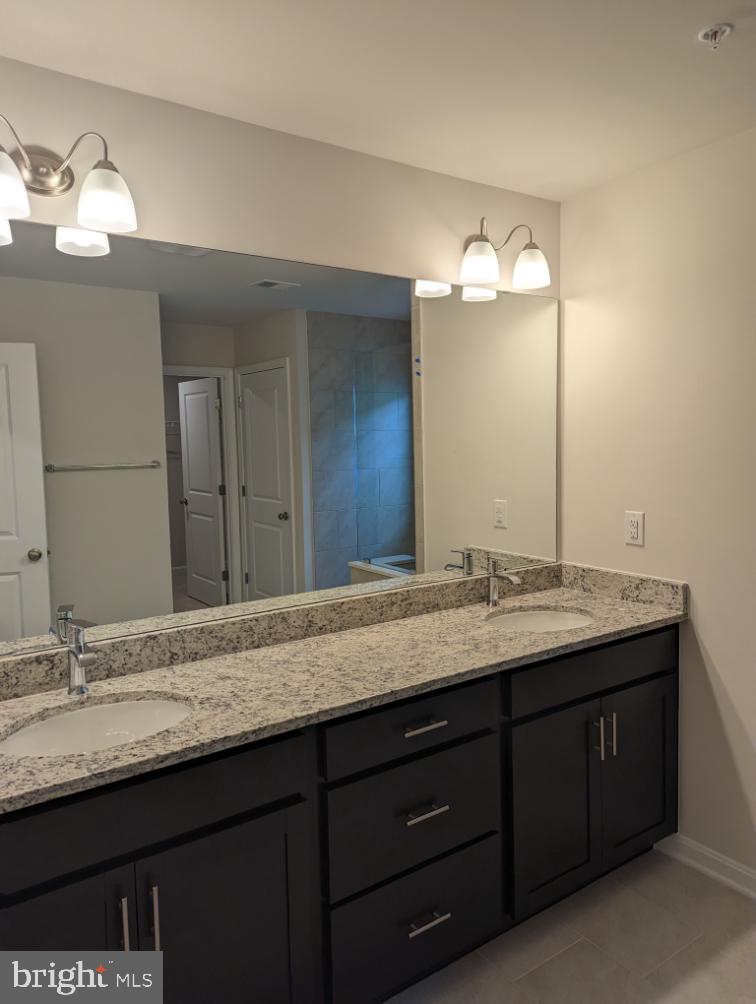 469 Hanson Street Frederick, MD 21701 - Photo 13 of 16 a bathroom with a granite countertop sink and a mirror