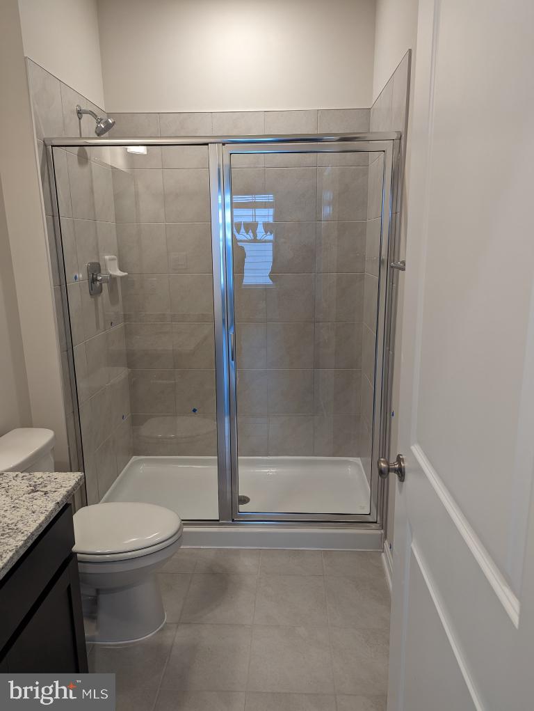 469 Hanson Street Frederick, MD 21701 - Photo 8 of 16 a bathroom with a shower a toilet and a sink