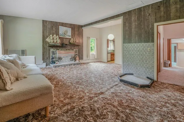 a view of a livingroom with furniture and staircase