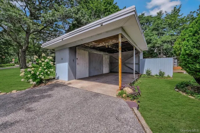 a view of a house with a yard and garage