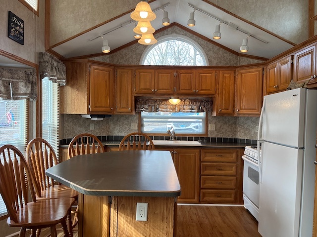 2795 East 28th Road Marseilles, IL 61341 - Photo 3 of 16 a kitchen with kitchen island a dining table chairs cabinets a sink and a refrigerator