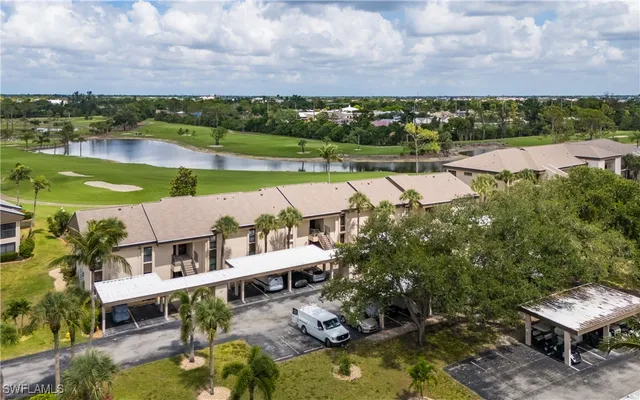 an aerial view of a house with a garden and lake view