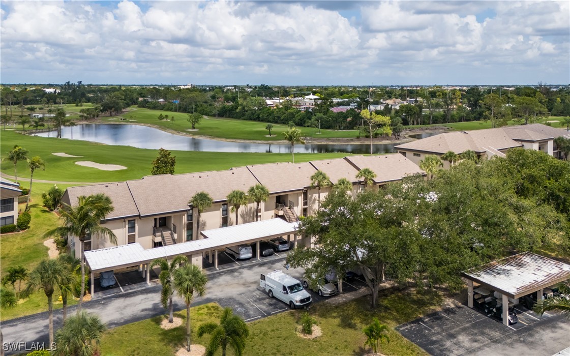 an aerial view of a house with a garden and lake view