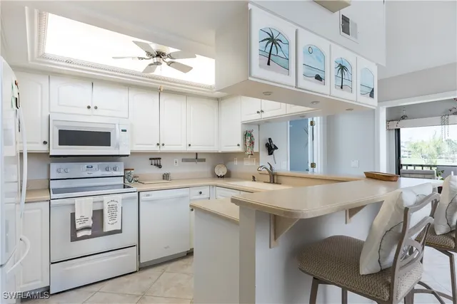a living room with furniture tv and a large window
