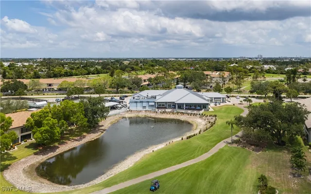 a house view with swimming pool and outdoor seating