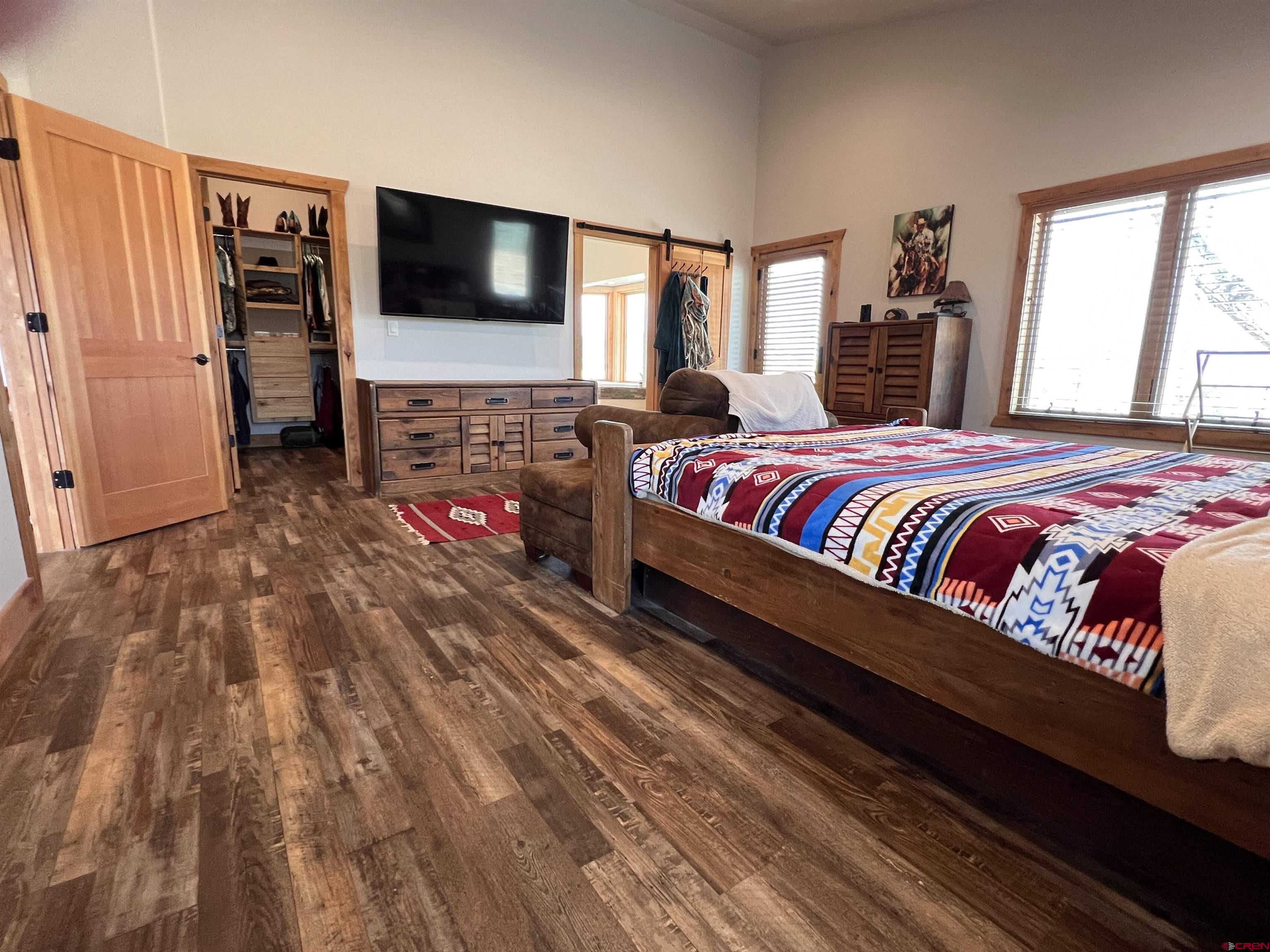 72997 O72 Road Montrose, CO 81401 - Photo 11 of 34 a bedroom with a bed and a flat screen tv