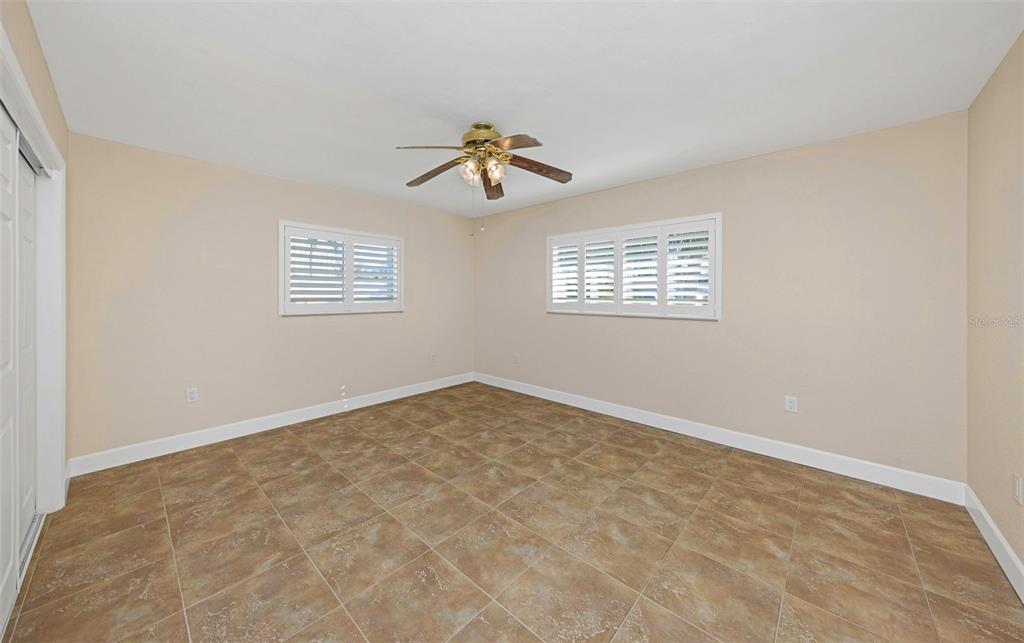 1445 Corey Way South South Pasadena, FL 33707 - Photo 34 of 61 an empty room with windows and fan