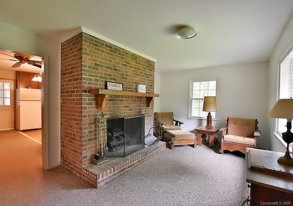 8940 Collins Road Indian Land, SC 29707 - Photo 5 of 28 a living room with furniture and a fireplace