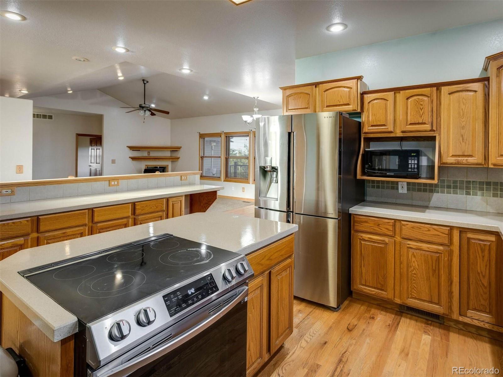 11200 County Road Wiggins, CO 80654 - Photo 13 of 40 a kitchen with stainless steel appliances a stove a sink and a refrigerator