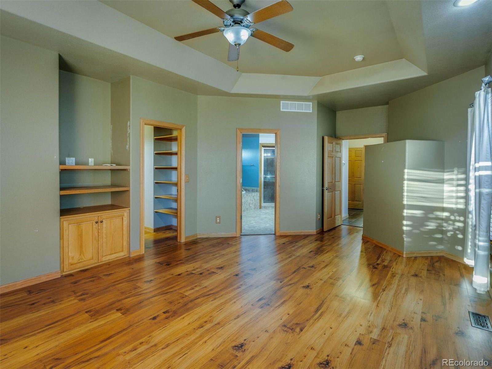 11200 County Road Wiggins, CO 80654 - Photo 21 of 40 wooden floor in an empty room with a window