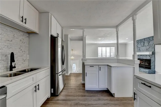 a kitchen with stainless steel appliances granite countertop a stove and a sink