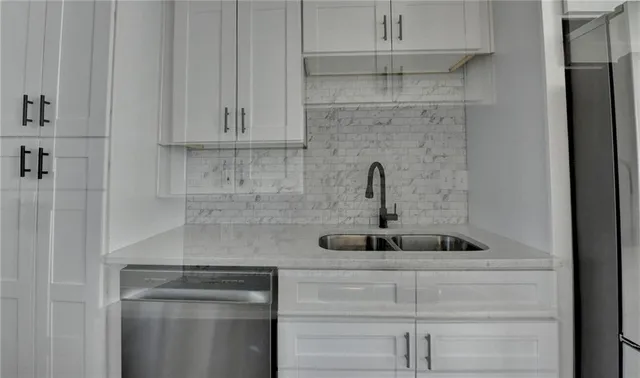 a kitchen with a sink cabinets and wooden floor