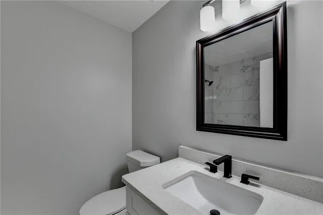 a kitchen with stainless steel appliances granite countertop a stove top oven a sink dishwasher and a refrigerator