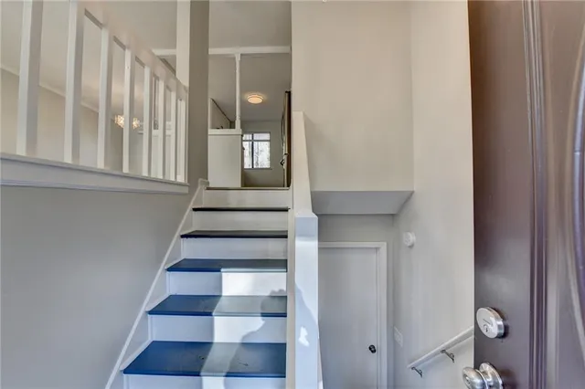 a view of an empty room with a window and fireplace