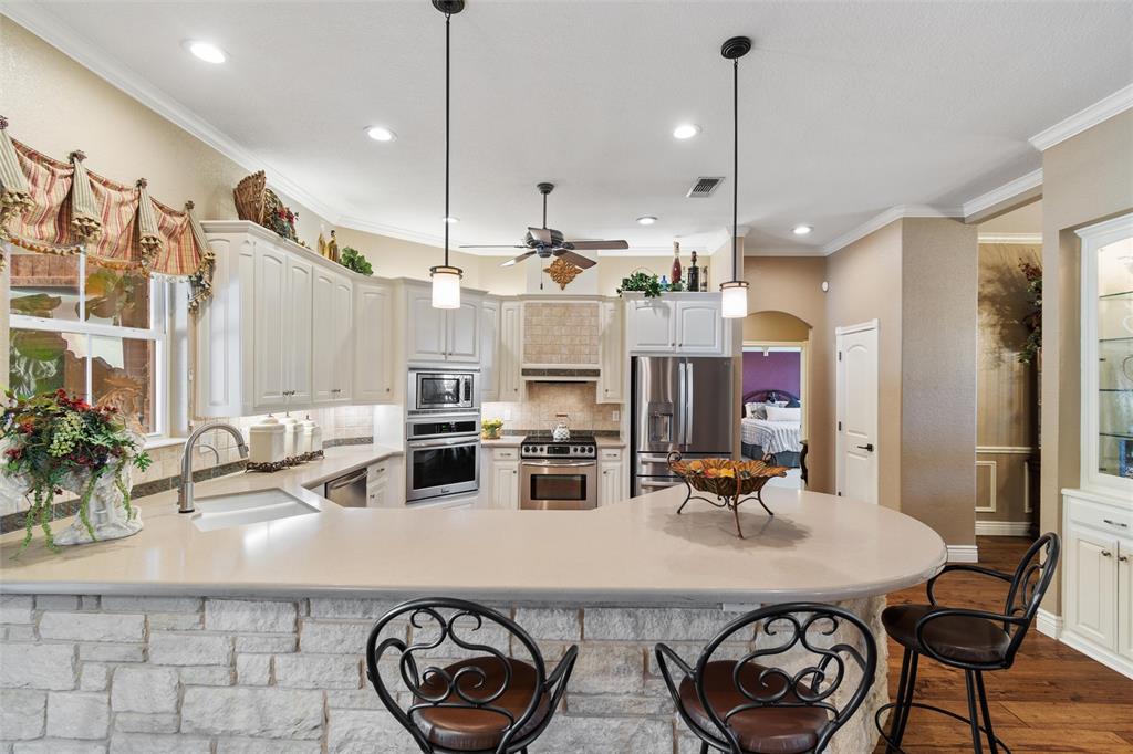 102 Ridge Court Glen Rose, TX 76043 - Photo 13 of 39 a kitchen with stainless steel appliances granite countertop a sink a stove and a refrigerator