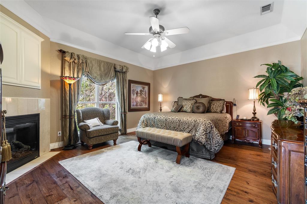 102 Ridge Court Glen Rose, TX 76043 - Photo 14 of 39 a bedroom with a large bed and a couch