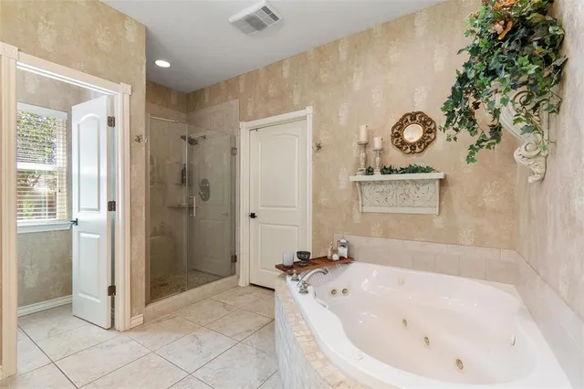 a bathroom with a tub and shower