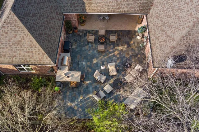 a view of a patio with couches table and chairs and potted plants
