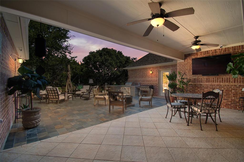 102 Ridge Court Glen Rose, TX 76043 - Photo 29 of 39 a view of a patio with dining table and chairs with plants and a barbeque grill