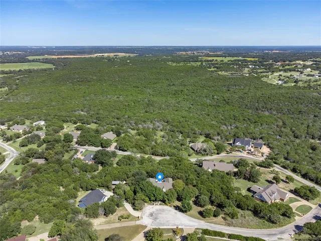 an aerial view of a house with swimming pool and garden