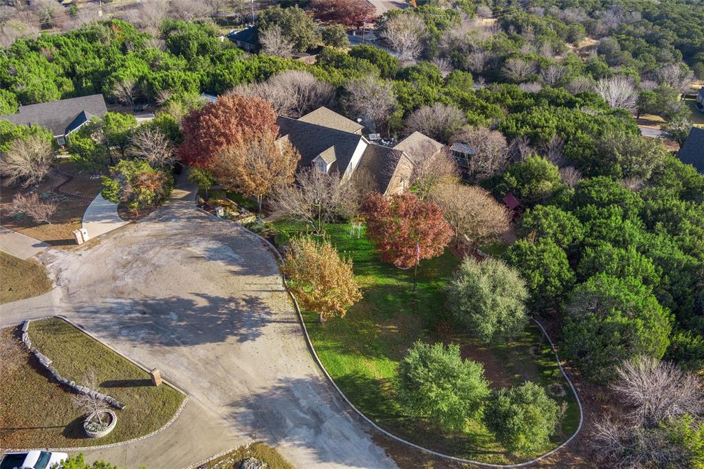 102 Ridge Court Glen Rose, TX 76043 - Photo 5 of 39 an aerial view of a house with a yard and greenery