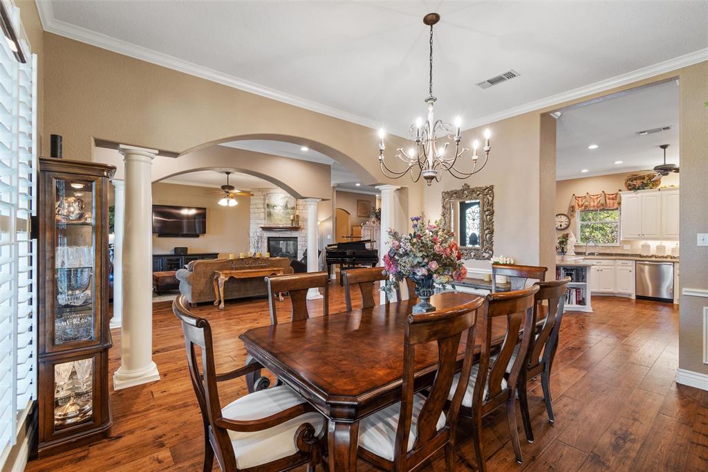102 Ridge Court Glen Rose, TX 76043 - Photo 9 of 39 a dining room with furniture a chandelier and wooden floor