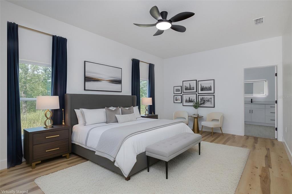 11277 Fool Duck Avenue Weeki Wachee, FL 34613 - Photo 12 of 75 a bedroom with a large bed and a chandelier