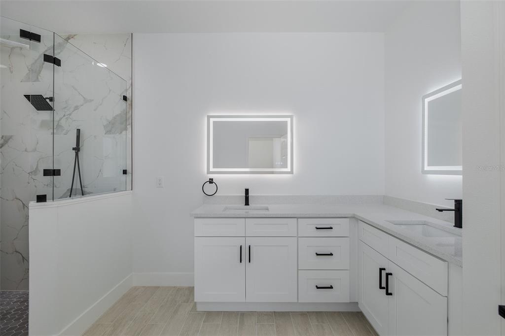 11277 Fool Duck Avenue Weeki Wachee, FL 34613 - Photo 14 of 75 a bathroom with a sink vanity granite and a mirror