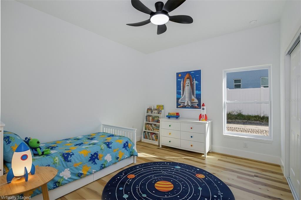 11277 Fool Duck Avenue Weeki Wachee, FL 34613 - Photo 18 of 75 a room with toys and dresser with wooden floor